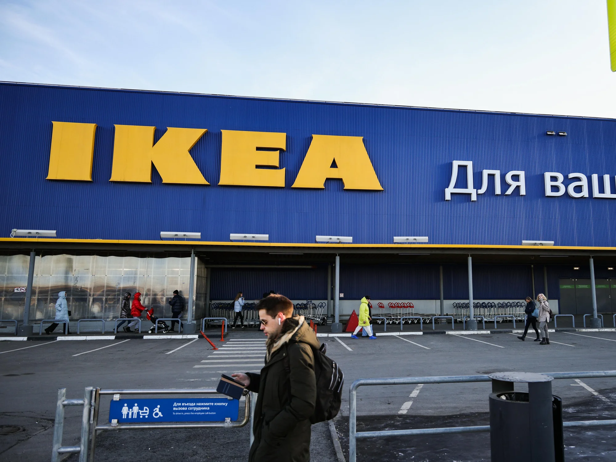 photo-of-a-man-walking-in-front-of-ikea-store