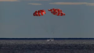 În această fotografie furnizată de NASA, nava spațială Orion pentru misiunea Artemis I se scufundă în Oceanul Pacific după o misiune de 25,5 zile pe Lună, duminică, 11 decembrie 2022. (NASA via AP)